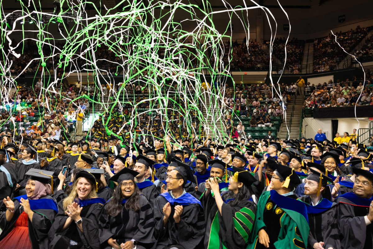 Graduates celebrate with confetti overhead