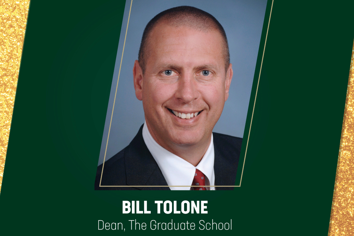 Bill Tolone, Dean of the Graduate School, photo of dean smiling with confetti surrounding headshot