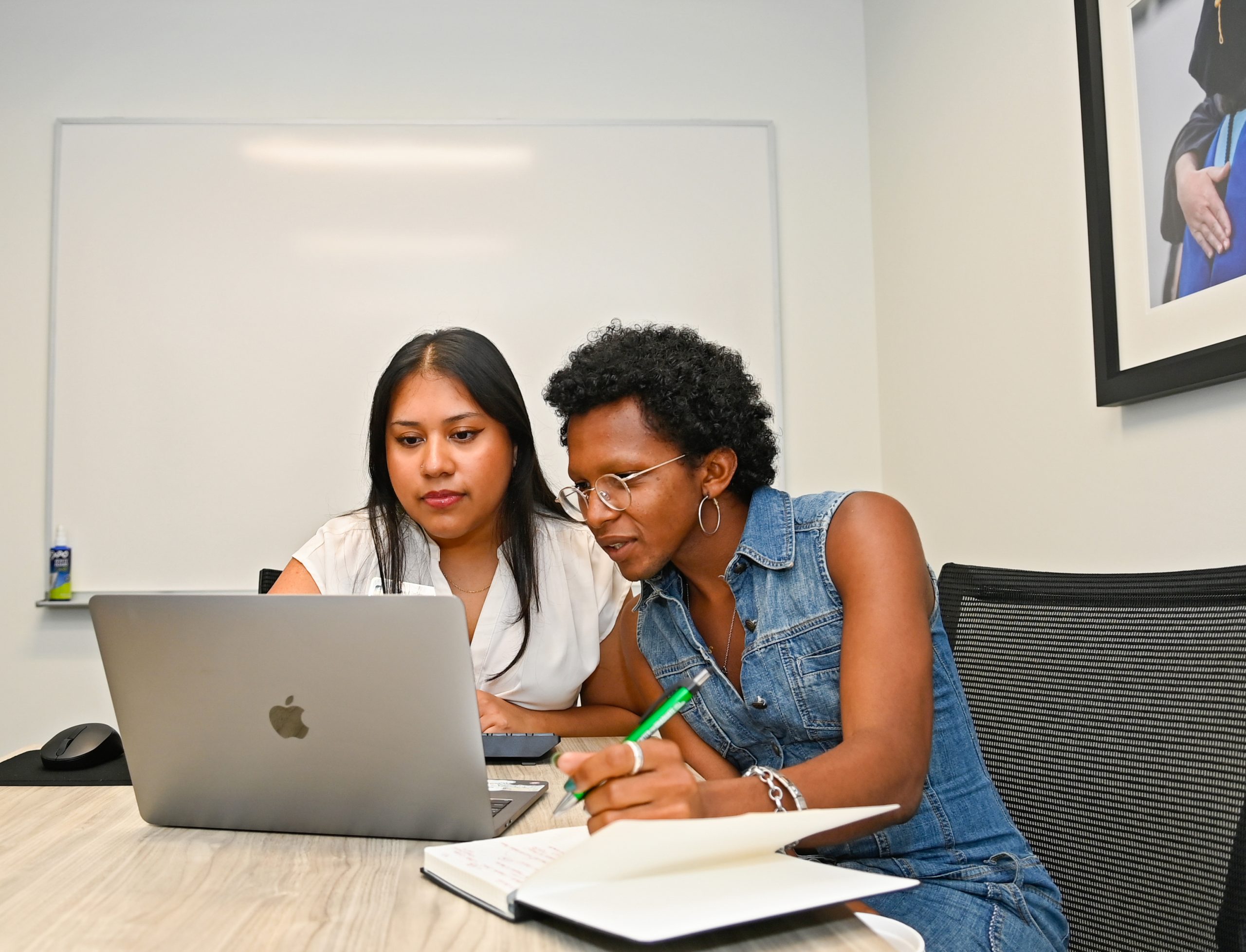 Students utilize the Writing Room. The space includes a smart TV and whiteboard to maximize collaboration and is available for reservation via email.